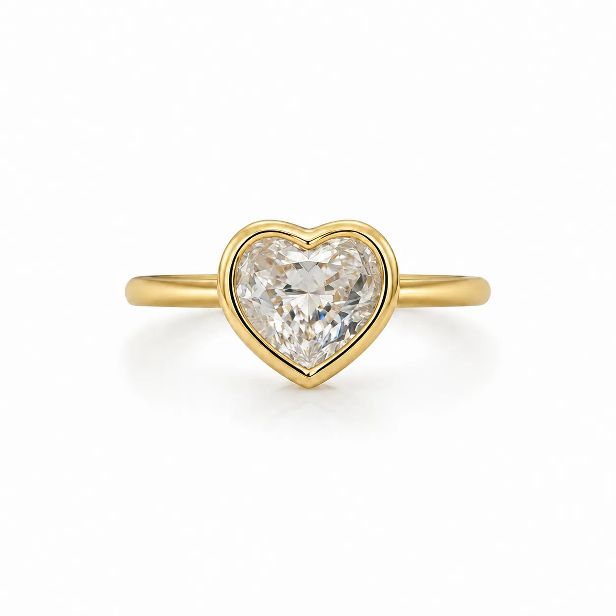Gold heart-shaped diamond ring on a white background