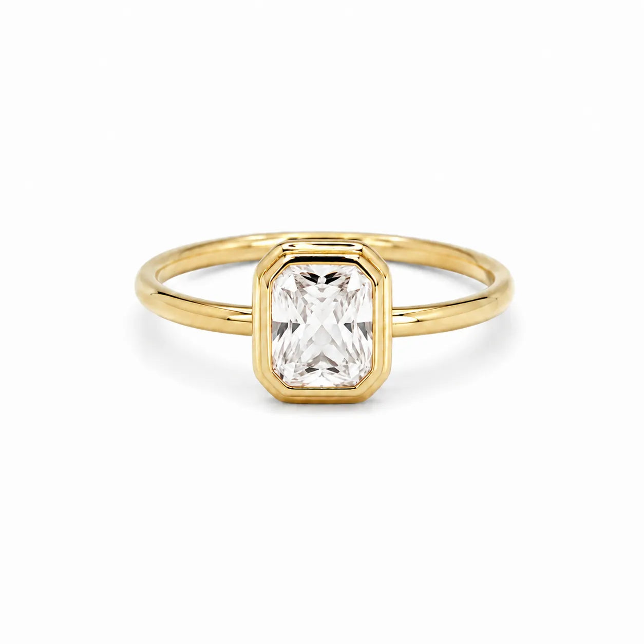 Gold ring with a rectangular diamond on a white background