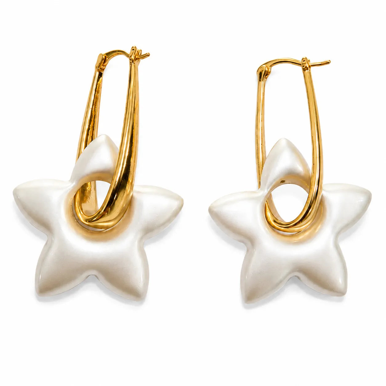 Star-shaped earrings with gold hoops on a white background