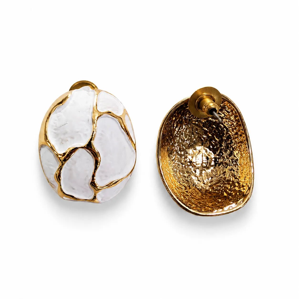 Gold and white earrings on a white background