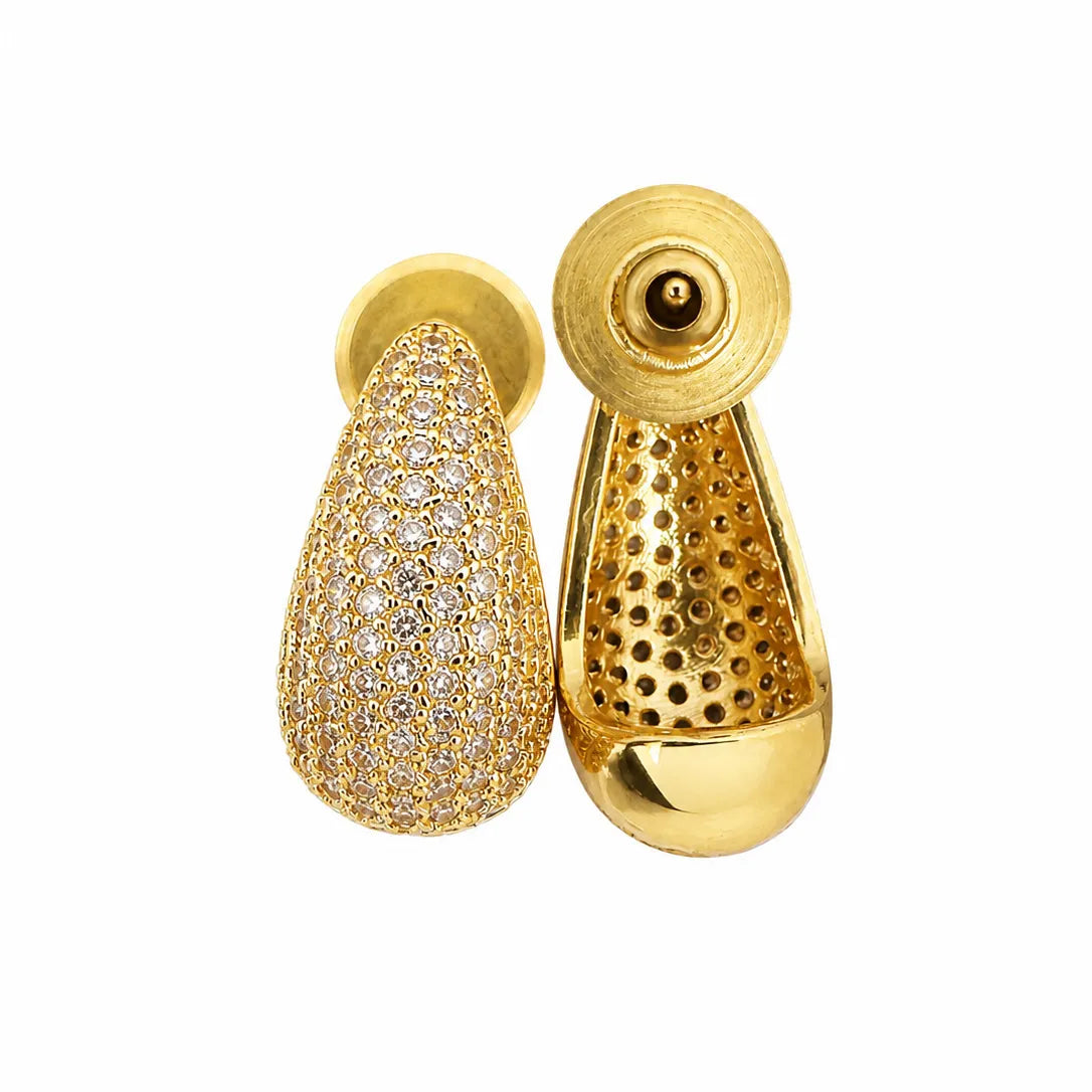 Gold earrings with one teardrop-shaped and one textured design on a white background