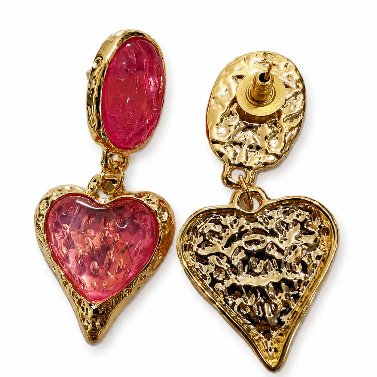 Gold heart-shaped earrings with pink gemstones on a white background