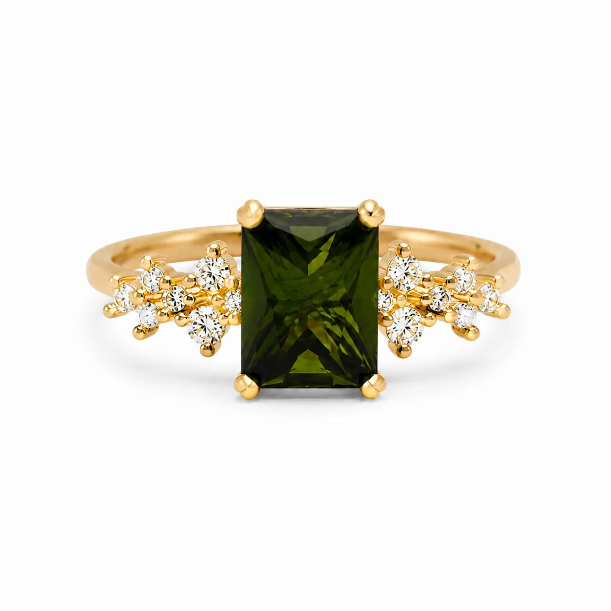 Gold ring with a green gemstone and diamond accents on a white background