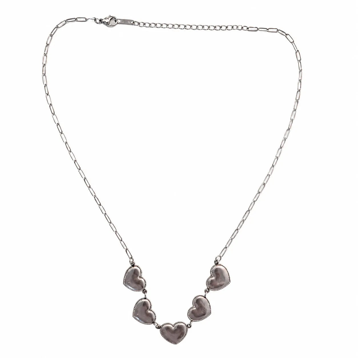 Silver necklace with heart-shaped pendants on a white background