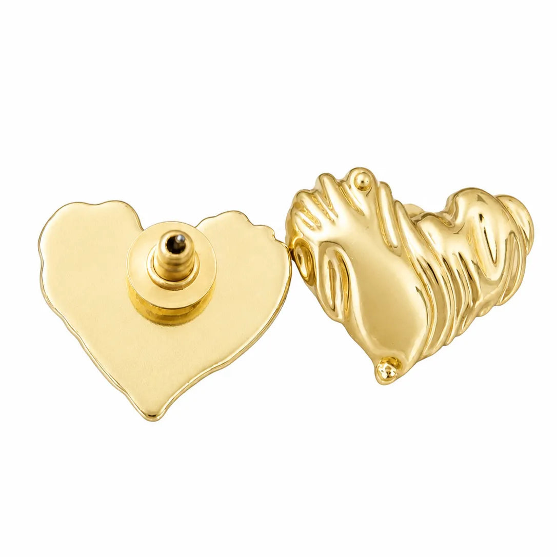 Gold heart-shaped earring with a hand design on a white background