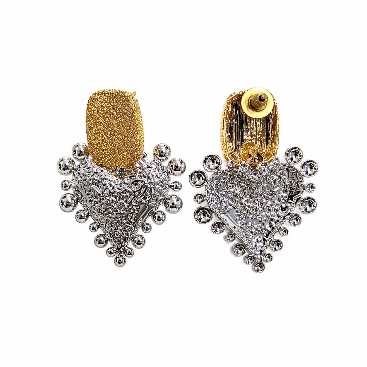 Pair of gold and silver heart-shaped earrings on a white background