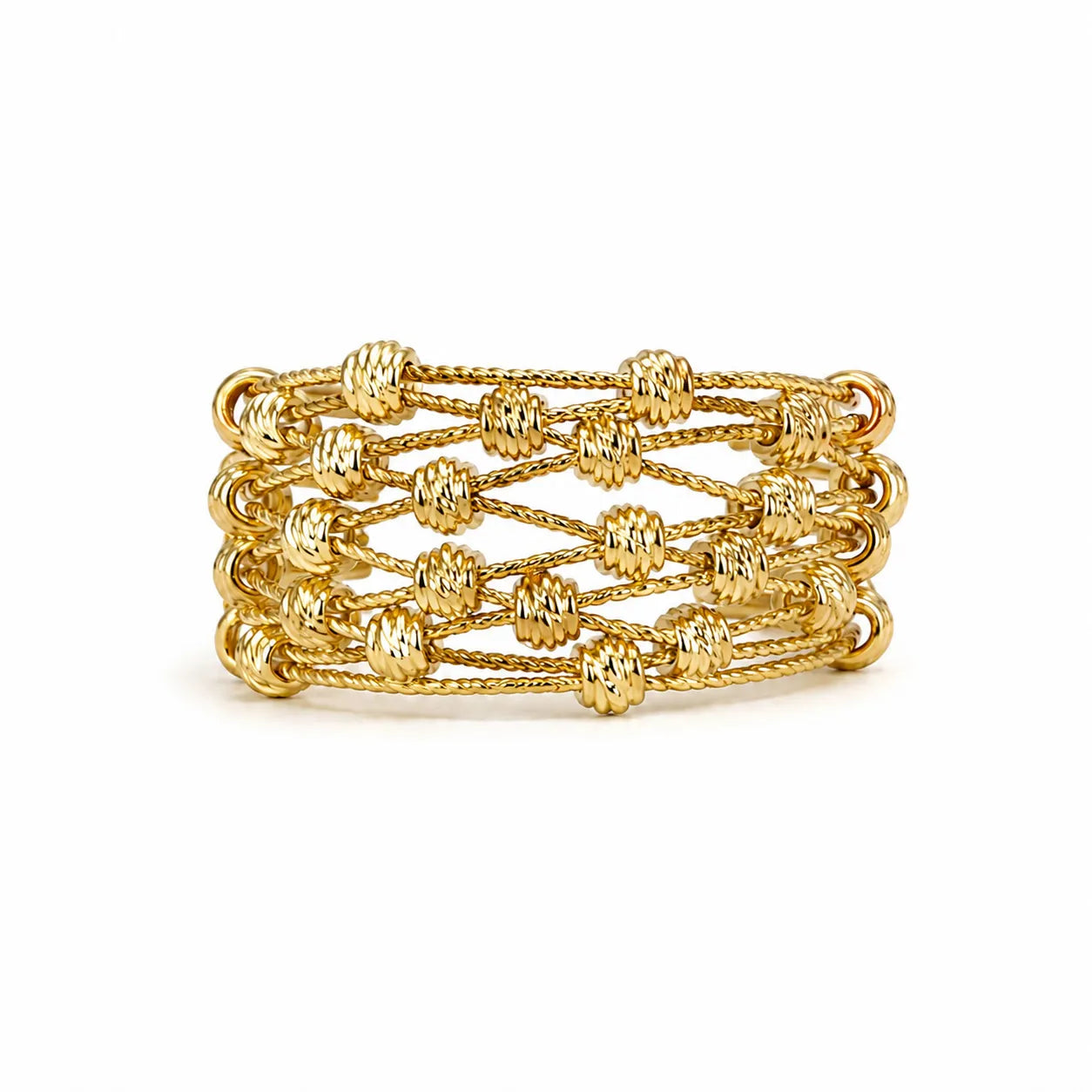 Stack of gold bracelets on a white background