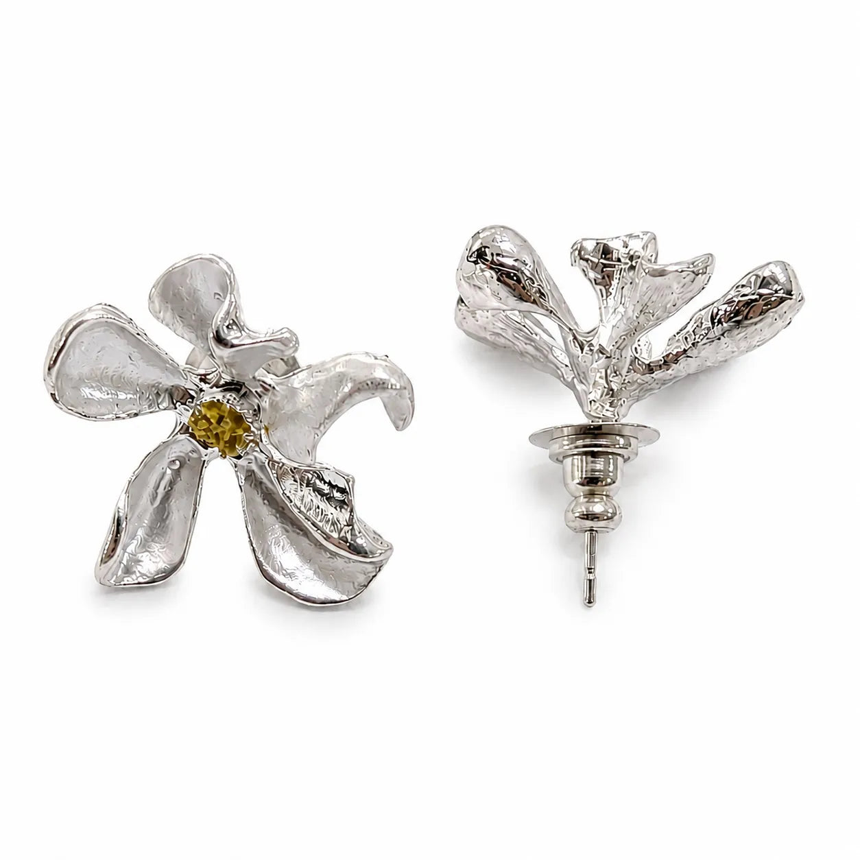 Silver flower-shaped earrings with a central gemstone on a white background