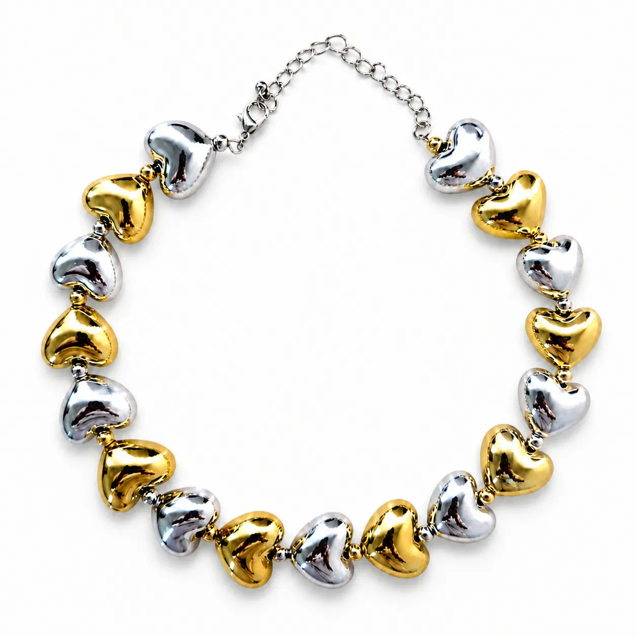 Necklace with heart-shaped beads in gold, silver, and bronze on a white background