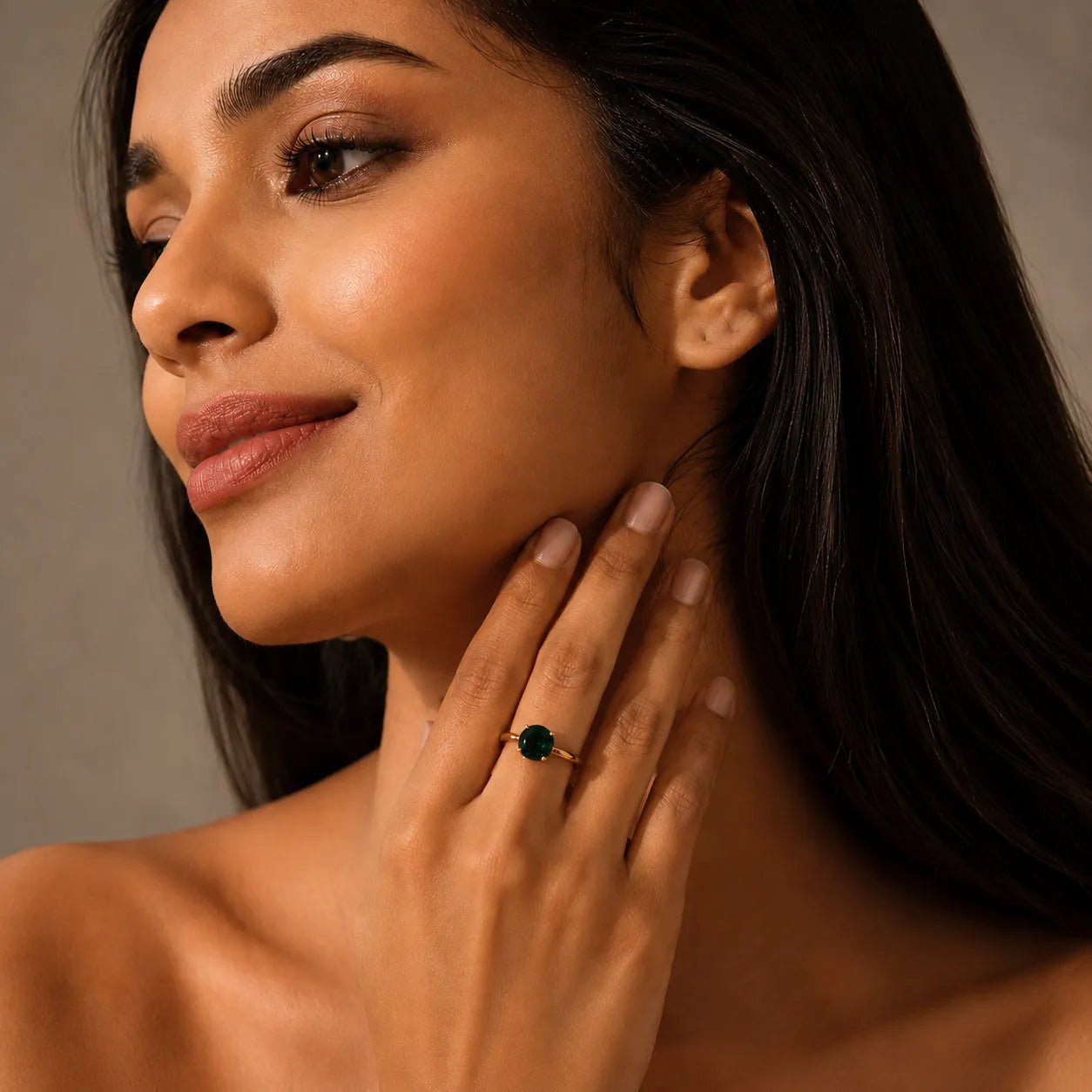 Woman wearing a green gemstone ring on her hand