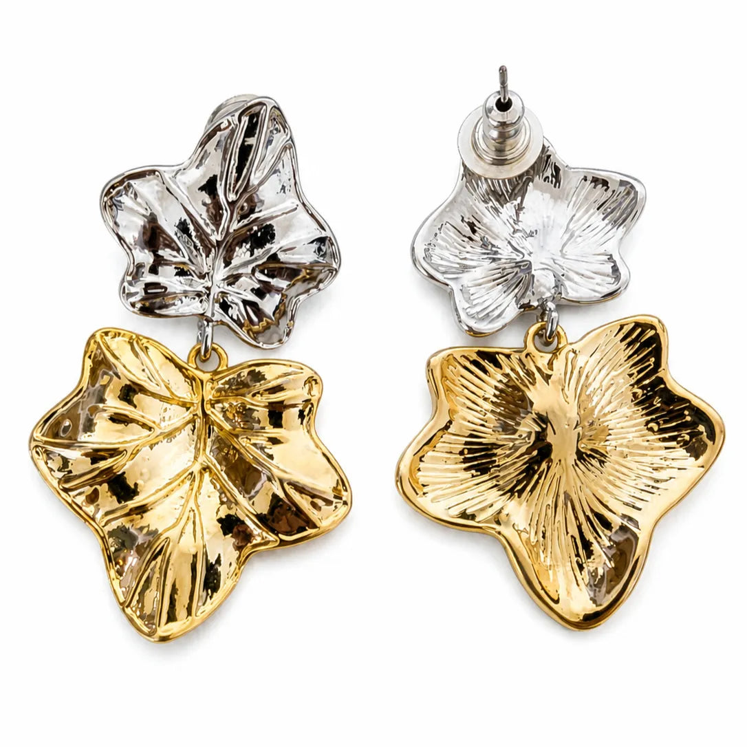 Pair of gold and silver leaf-shaped earrings on a white background