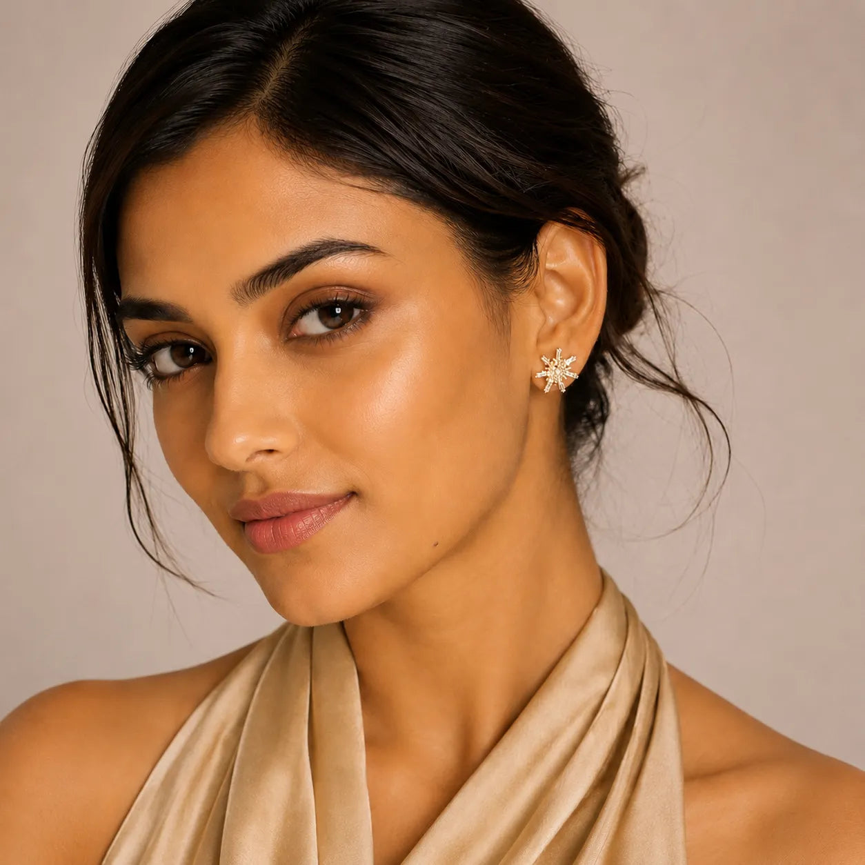 Woman wearing a beige scarf with a neutral background