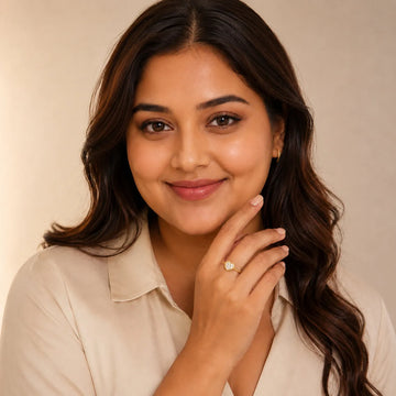 Woman wearing a ring on a beige background