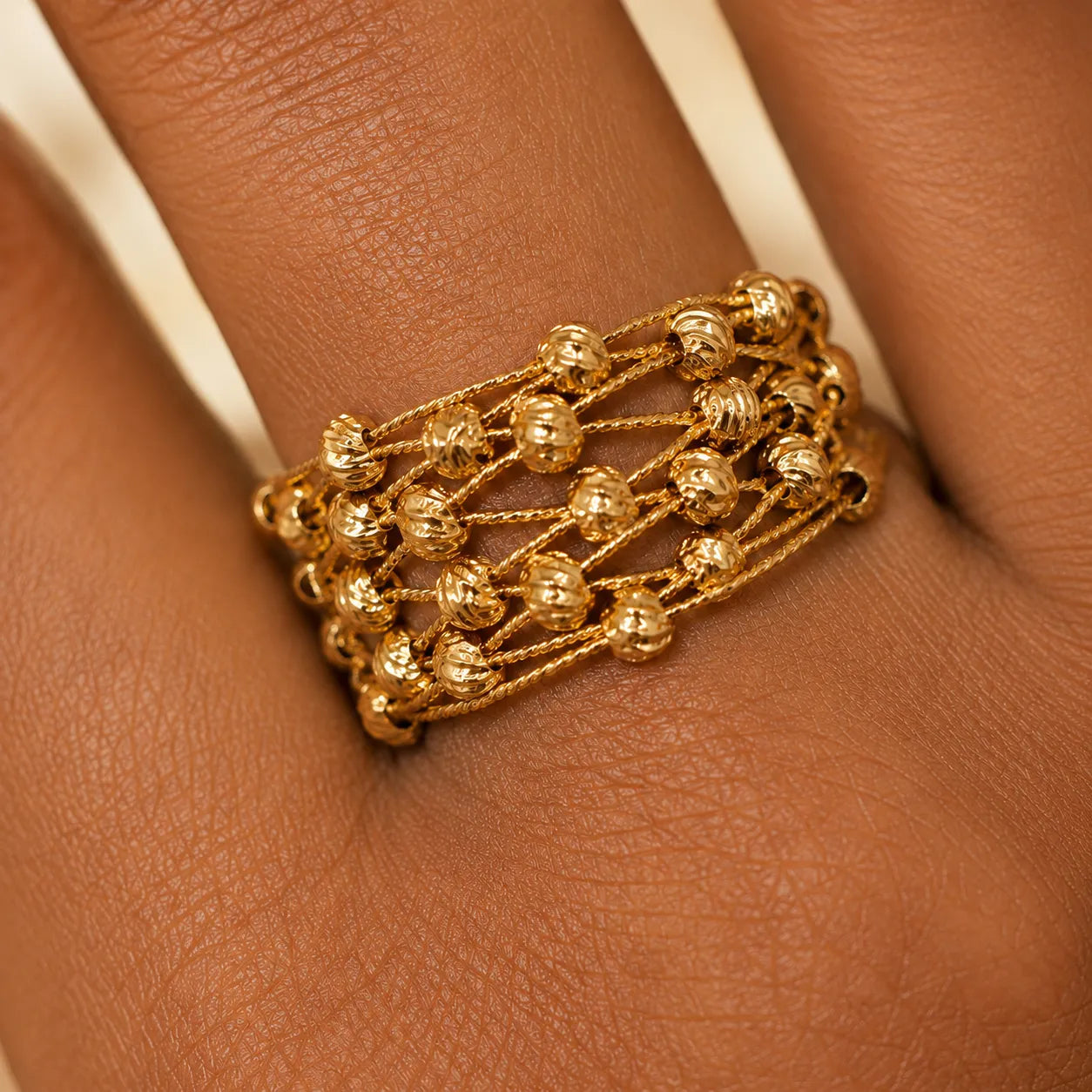 Gold bracelet on a person's wrist with a close-up view