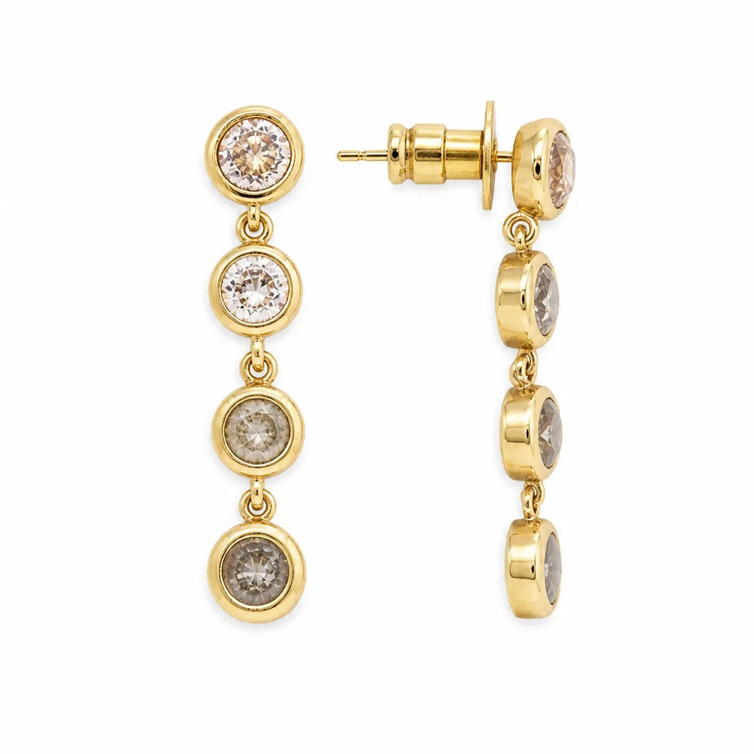 Gold earrings with multiple round gemstones on a white background