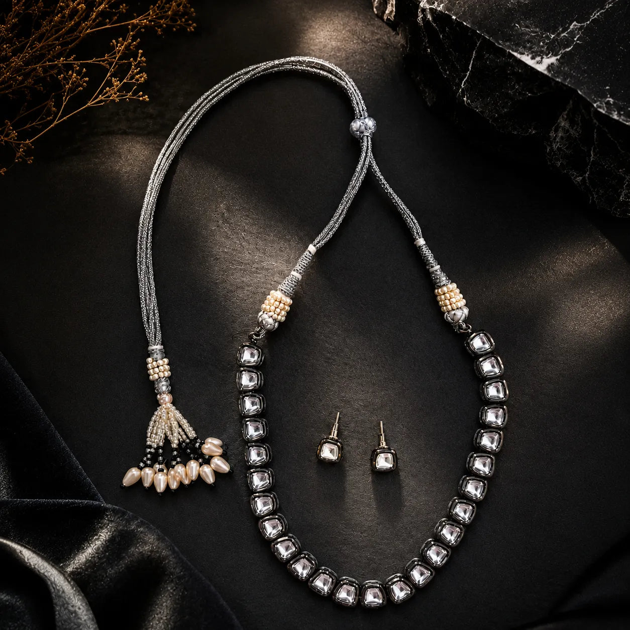 Jewelry set with necklace, earrings, and hair accessory on a dark surface