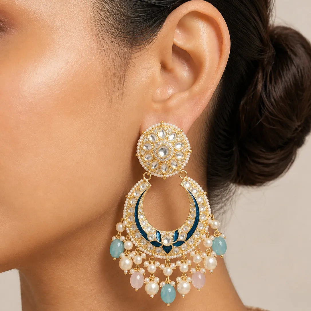 Close-up of a woman wearing an ornate earring with pearls and blue stones.