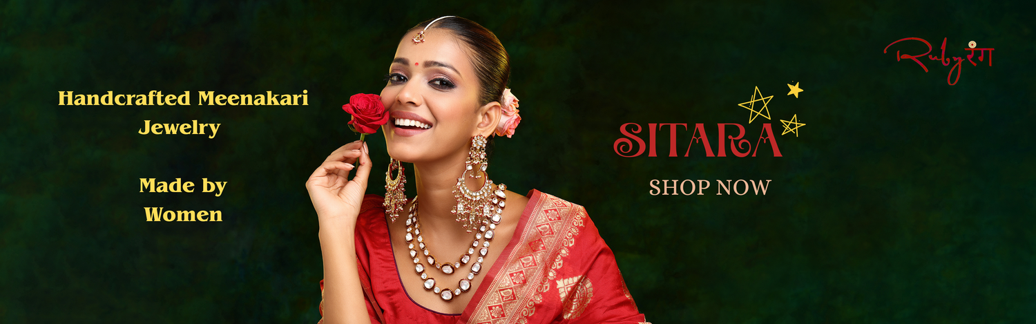 Woman in red traditional attire with Meenakari jewelry, holding a rose, on a dark green background with 'SITARA' branding. The newest Ruby Raang collection — now live.