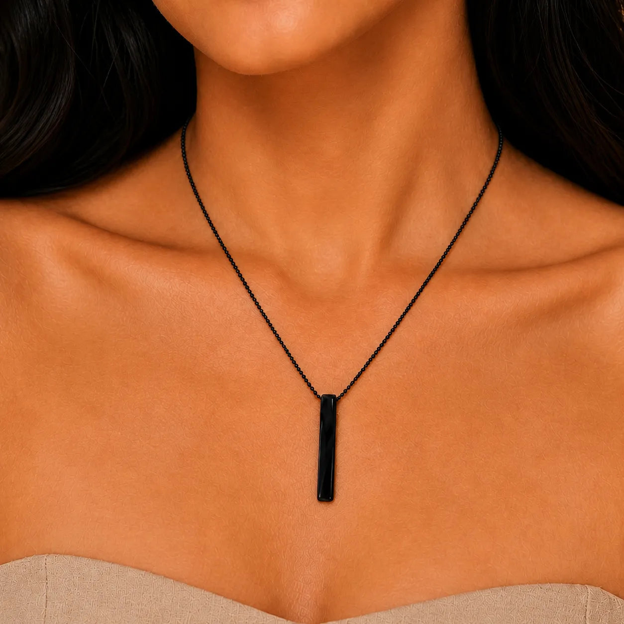 Black necklace with a pendant on a person's neck