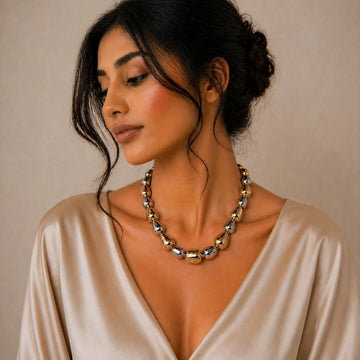 Woman wearing a necklace with a neutral background