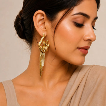 Woman wearing a gold earring with a neutral background