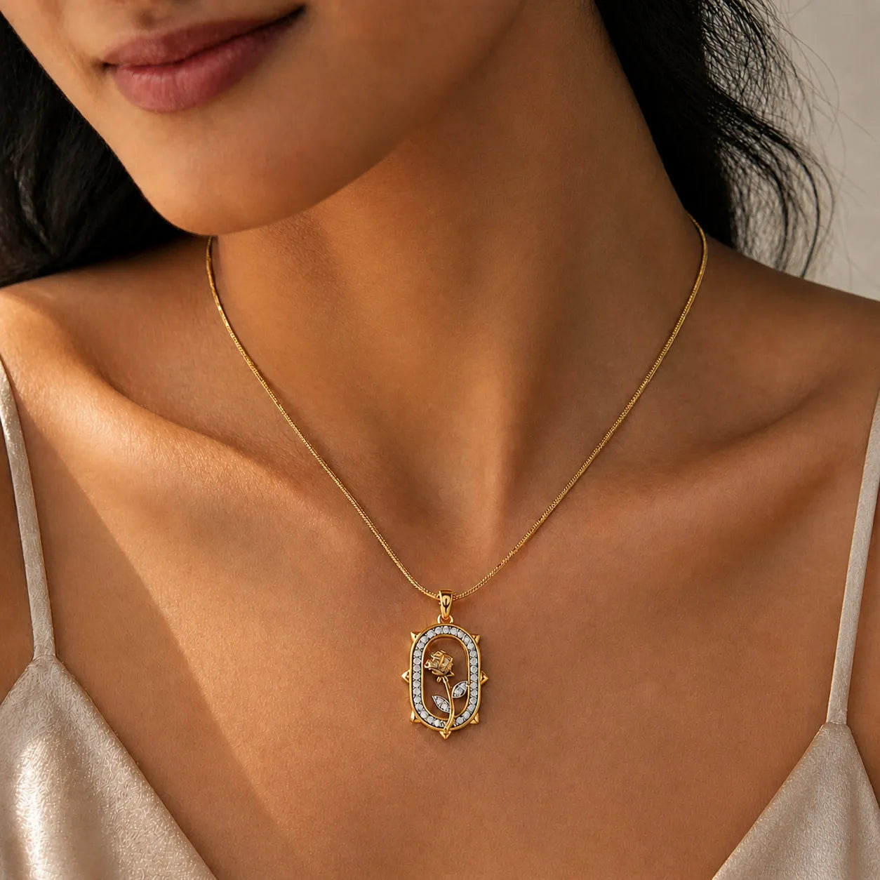 Close-up of a woman wearing a gold necklace with a pendant