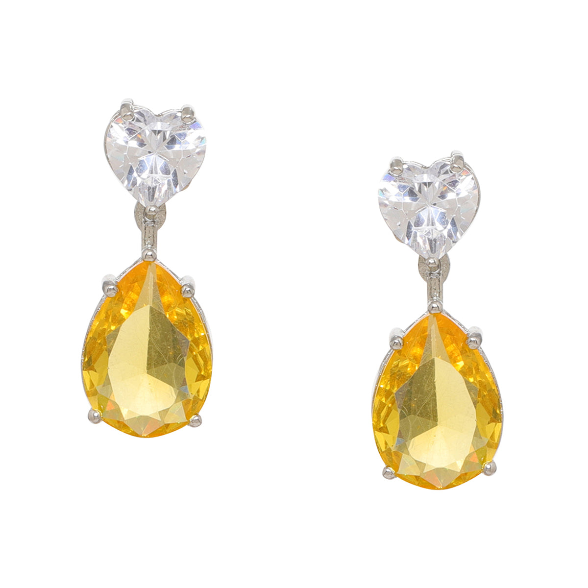 A pair of silver drop earrings featuring a clear heart-shaped crystal stud and a faceted yellow teardrop gemstone below, set against a plain white background.
