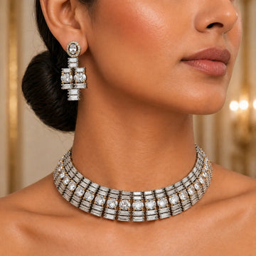 Close-up of a woman wearing a sparkling diamond necklace and earrings.